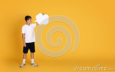 Shocked smiling caucasian teenage boy showing abstract cloud for ad and offer with copy space Stock Photo