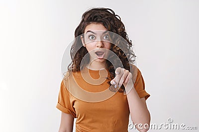 Shocked speechless impressed attractive young female drop jaw gasping surprised pointing camera widen eyes see Stock Photo