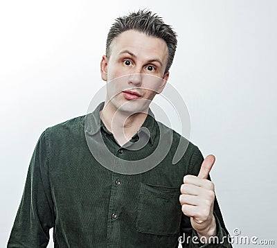 Shocked stunned young man pointing finger aside at blank copy space advertising unbelievable presentation, astonished surprised Stock Photo