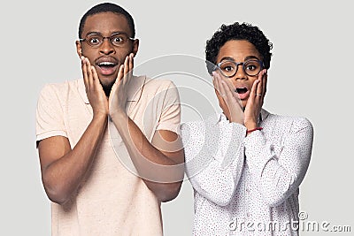 Shocked surprised african american young family couple looking at camera. Stock Photo
