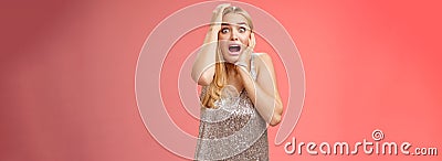 Shocked terrified blond woman horrified see crime screaming pop eyes shouting hold hands head afraid trembling fear Stock Photo