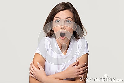 Shocked terrified young woman feeling afraid isolated on grey background Stock Photo