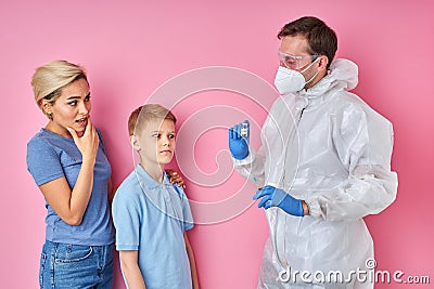 Shocked woman with kid boy look on syringe in fear Stock Photo