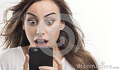 Shocked woman looking at phone, Young girl shocked looking at mobile Stock Photo