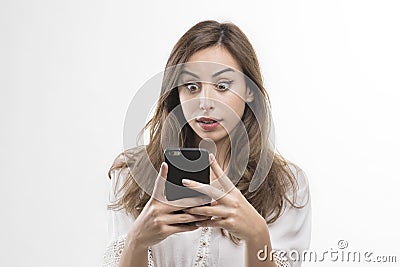 Shocked woman looking at phone, Young girl shocked looking at mobile Stock Photo