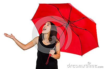 Shocked woman looking up while holding red umbrella Stock Photo