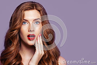 Shocked woman portrait. Surprised redhead girl with opened mouth Stock Photo