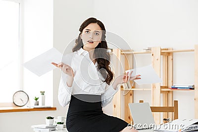 Shocked young business woman surprised by reading unexpected news in document, amazed woman office worker feeling Stock Photo