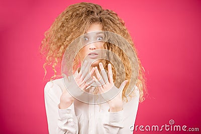 Shocked young woman with blond unruly hair after going to the hairdressing salon Stock Photo