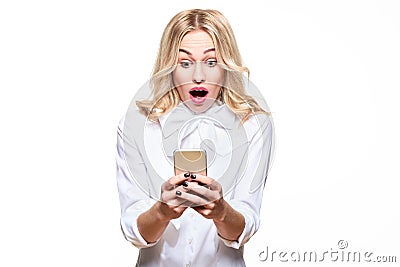 Shocked young woman looking at her mobile phone, screaming in disbelief. Woman staring at shocking text message on her phone. Stock Photo