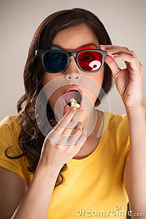 Shocked young woman watching 3D movie Stock Photo