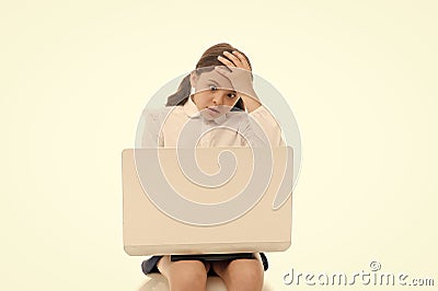 Shocking content. Schoolgirl surfing internet with shocked face. Girl stunned expression touch her head. How can it be Stock Photo