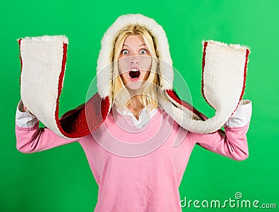 Shocking softness. Lets stay warm in fur clothing. Girl cheerful warming up wear fur hood on green background. Woman Stock Photo