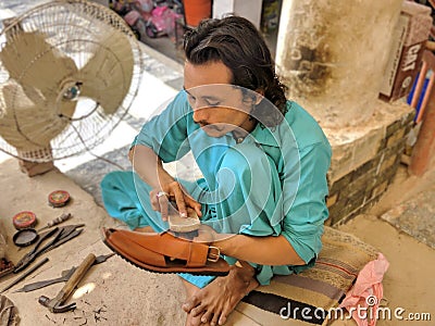 Shoe Maker from Pakistan. Poor labour doing hard work. Editorial Stock Photo