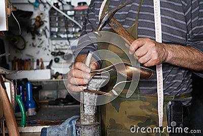 Shoe maker Repairing High Heel Shoe Stock Photo