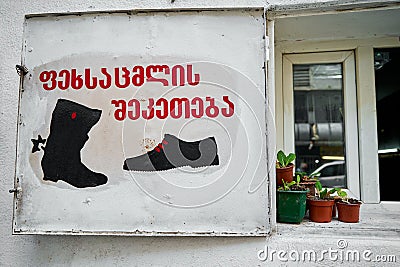 Shoe repair shop counter. Flower pots on the windowsill. Cozy exterior Editorial Stock Photo