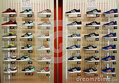 Shoe shop. Shelves with many sneakers. Editorial Stock Photo