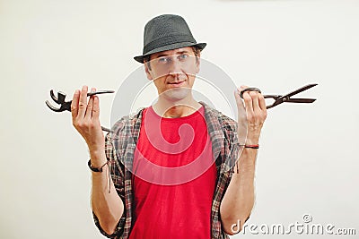 Shoemaker holding old cobbler tools in workshop. Small business concept Stock Photo