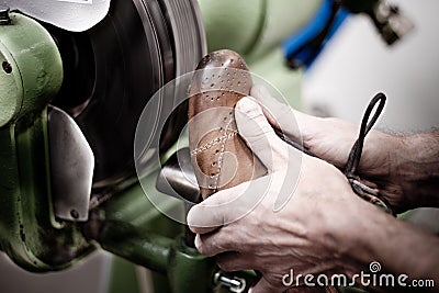 Shoemaker polishing sole of shoe Stock Photo