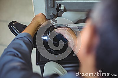 Shoemaker using sewing machine Stock Photo