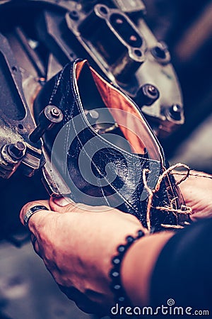 Shoemaker using special machine tool for making a shoes Stock Photo