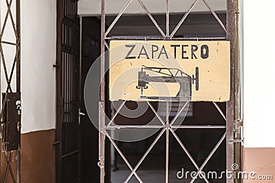 Shoemaker Zapatero in Spanish sign with sewing machine on a door in Havana, Cuba Stock Photo