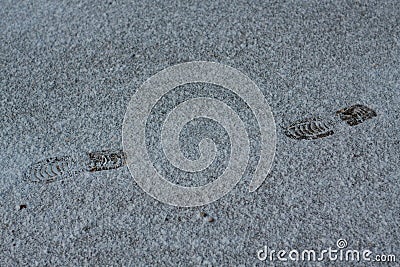 Fresh shoeprints on snow. Human feet traces, shoes imprints on snowy road Stock Photo