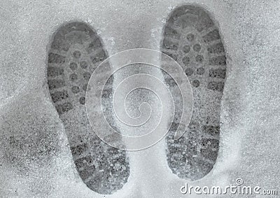 Shoeprints in melting snow Stock Photo
