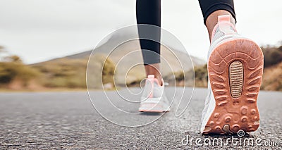 Shoes, athlete and road by a mountain outdoor ready to start a run for health and wellness. Feet, person and running Stock Photo