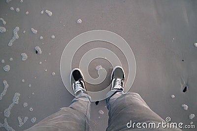 Shoes on the beach standing alone black skate Stock Photo