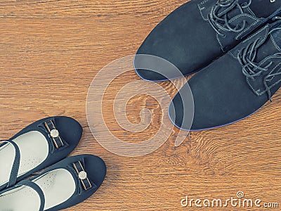 Shoes father and daughter`s shoes on the wooden floor. Stock Photo