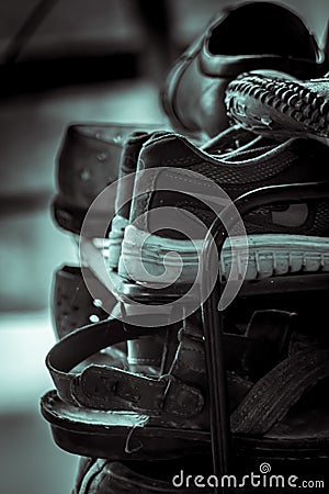 Shoes kept unorganized on the shoe rack Stock Photo