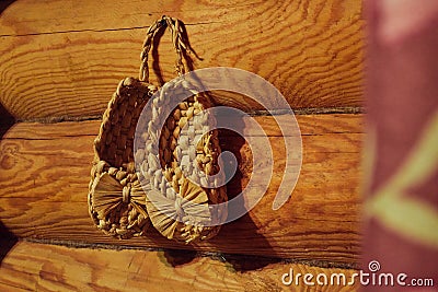 Shoes made of straw hanging on the wall Stock Photo