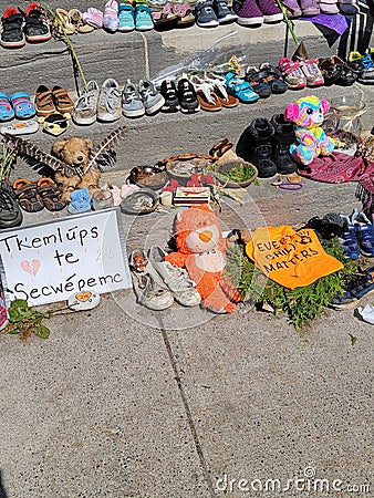 Shoes and teddy bears left on kingston city hall steps in memory of 215 children's graves found in kamloops Editorial Stock Photo