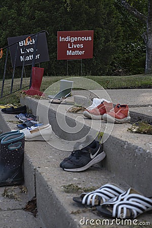 Shoes and toys at memorial by catholic church in tribute to 215 indigenous aboriginal children Editorial Stock Photo