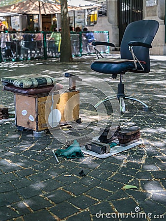 Shoeshiner Equipments in the Street: Chair, Wooden Footrest, Brushes and Rag Stock Photo