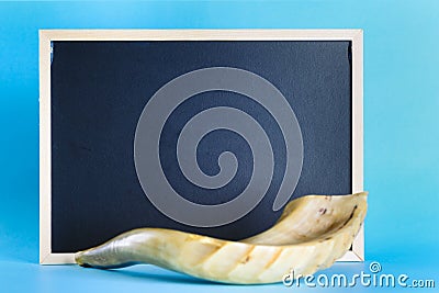 Shofar horn and chalkboard for text. Stock Photo