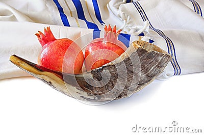 Shofar (horn), white prayer talit and pomegranate isolated on white. rosh hashanah (jewish holiday) concept . traditional holiday Stock Photo