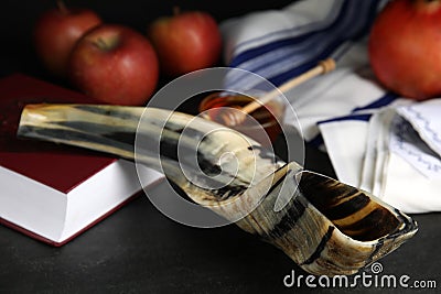 Shofar and Torah on black table, closeup. Rosh Hashanah celebration Stock Photo