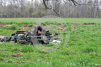 Shooter Lying in Grass Stock Photo