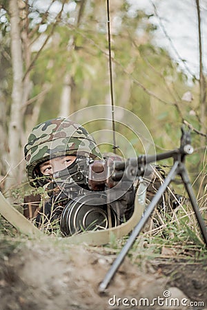 Shooter lying in the grass Stock Photo