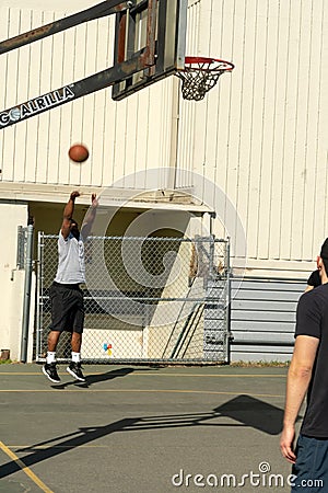 Shooting basketball at hoop Editorial Stock Photo