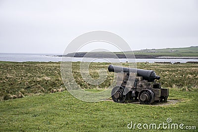 Shooting cannon Orkney coastline cliff landscape Stock Photo