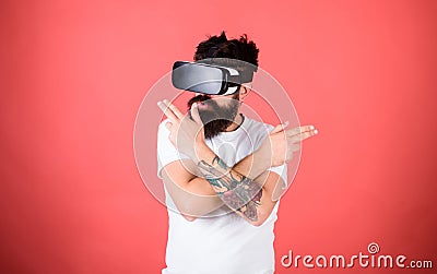 Shooting gallery VR. Man bearded hipster with virtual reality headset on red background. Man hand gesture as gun play Stock Photo