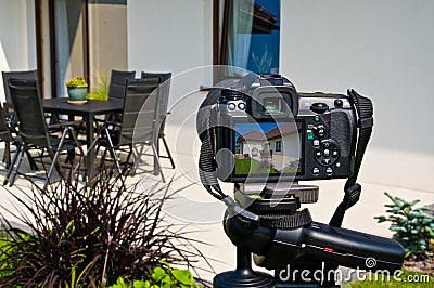 Shooting house exterior, photographer camera, tripod and ballhead Stock Photo