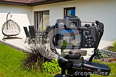 Shooting house exterior, photographer camera, tripod and ballhead Stock Photo