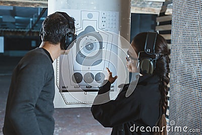 shooting instructor pointing on used target Stock Photo