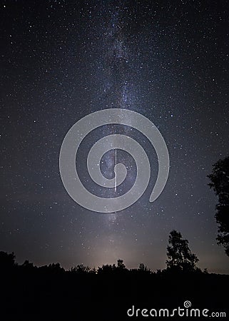 Shooting star and Milk Way. Perseid meteor shower night sky. Stock Photo