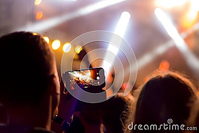 Shooting concert on smartphone Stock Photo