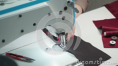 Shooting of tailor woman sewing order on electric machine Stock Photo